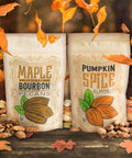 Maple Bourbon Pecans and Pumpkin Spice Almonds surrounded by autumn leaves