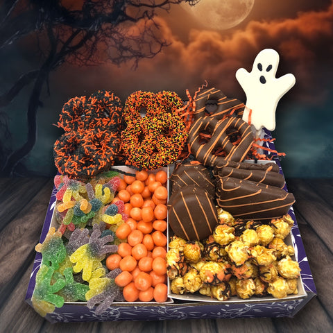 Halloween Boo Box filled with chocolate-covered pretzels, cookies, caramel corn, and gummies, perfect for gifting or parties.