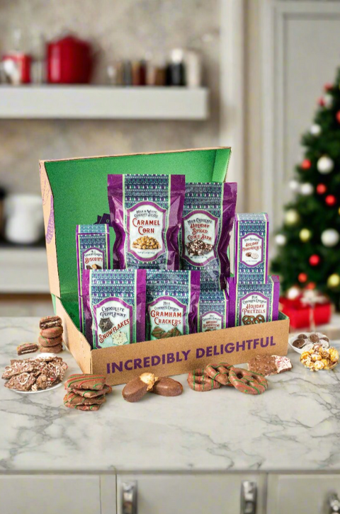 Festive chocolate gift box with assorted treats, pretzels, and cookies displayed on a holiday-themed table.