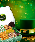 St. Patrick's Day snack box with chocolates, nuts, pretzels, caramel corn, and a green hat surrounded by gold coins.