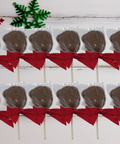 Milk chocolate Santa lollipops with red bows, set of 12 handcrafted Christmas treats, perfect for gourmet holiday gifts and stocking stuffers.