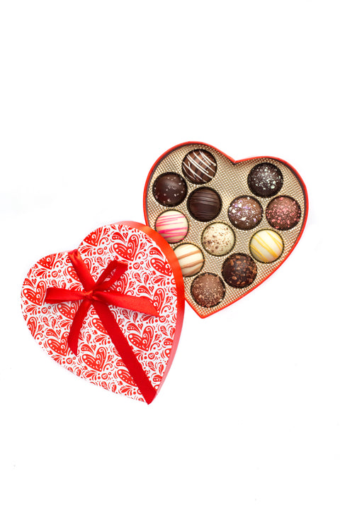 Heart-shaped box of Valentine's Day truffles with an assortment of white, dark, and milk chocolate flavors.