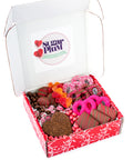 Valentine's Day Box with chocolate-covered pretzels, cookies, and graham crackers in a red decorative box.