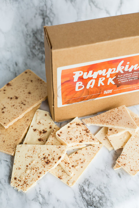 Pumpkin Bark Variety Box with handcrafted gourmet chocolate pieces on a marble surface.